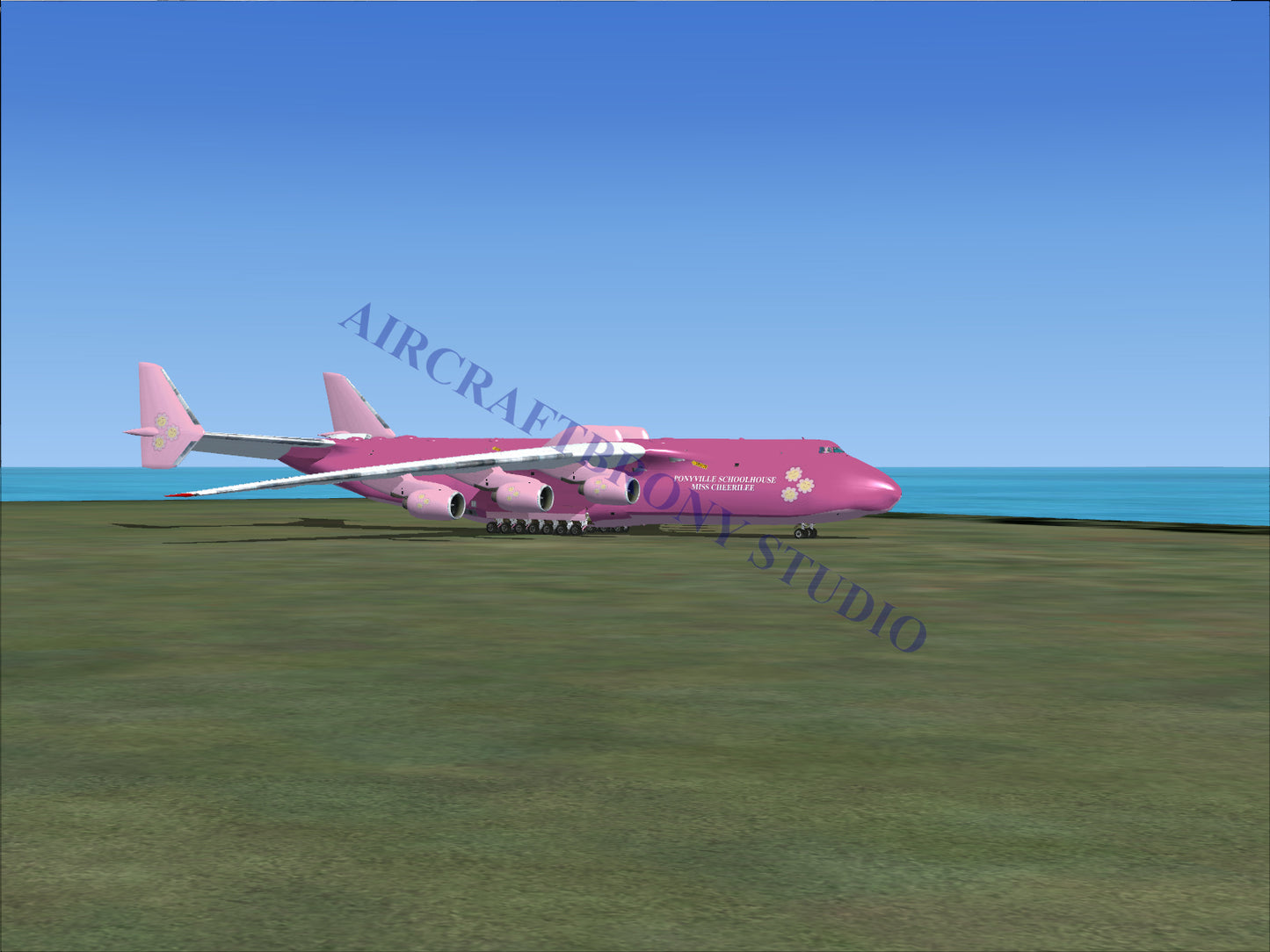 Pink cargo aircraft on a grassy field.