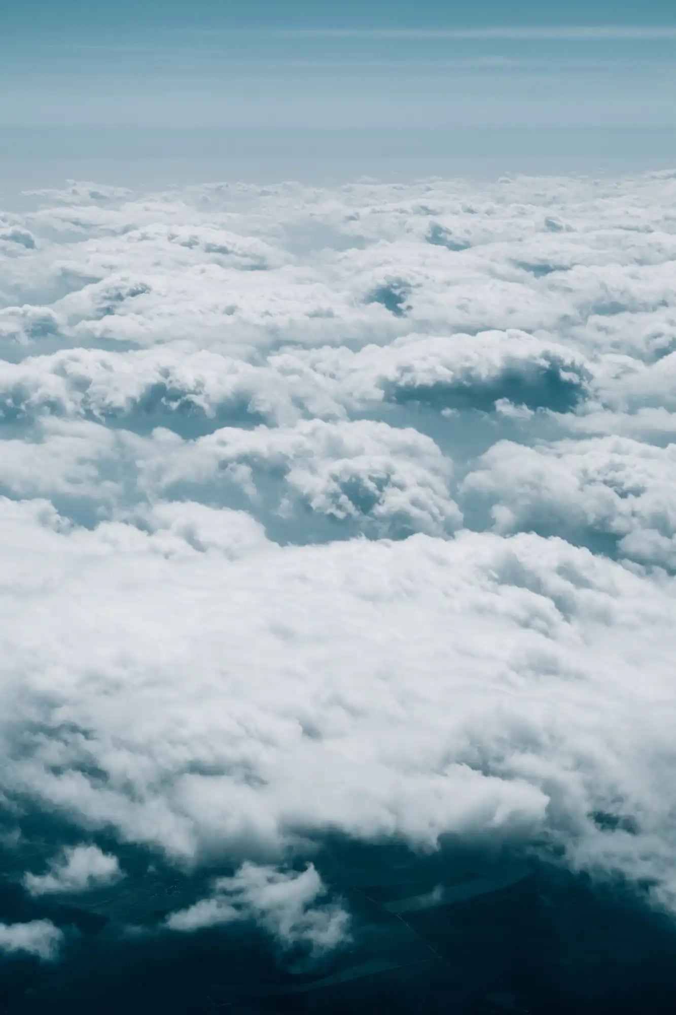 Fluffy white clouds seen from above.