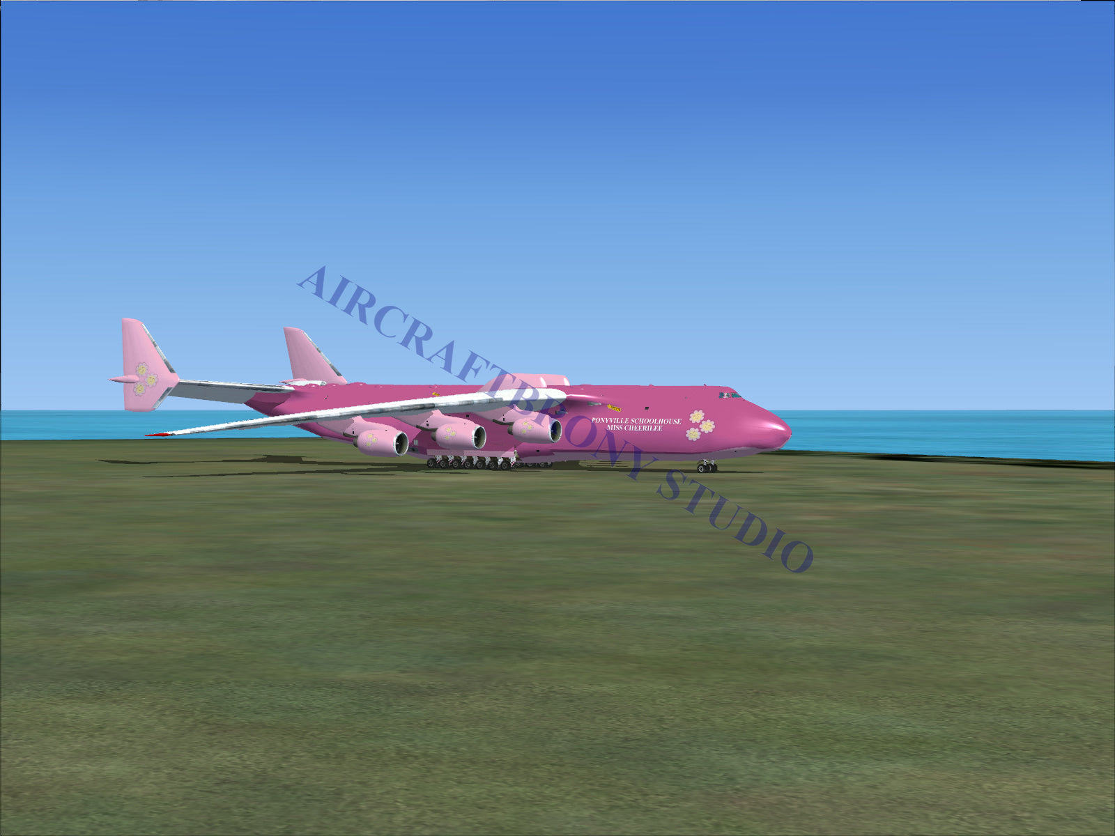 Pink cargo aircraft on a grassy field.
