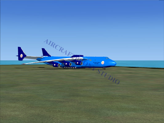 Blue cargo plane with white logo and tail design, parked on tarmac near ocean.